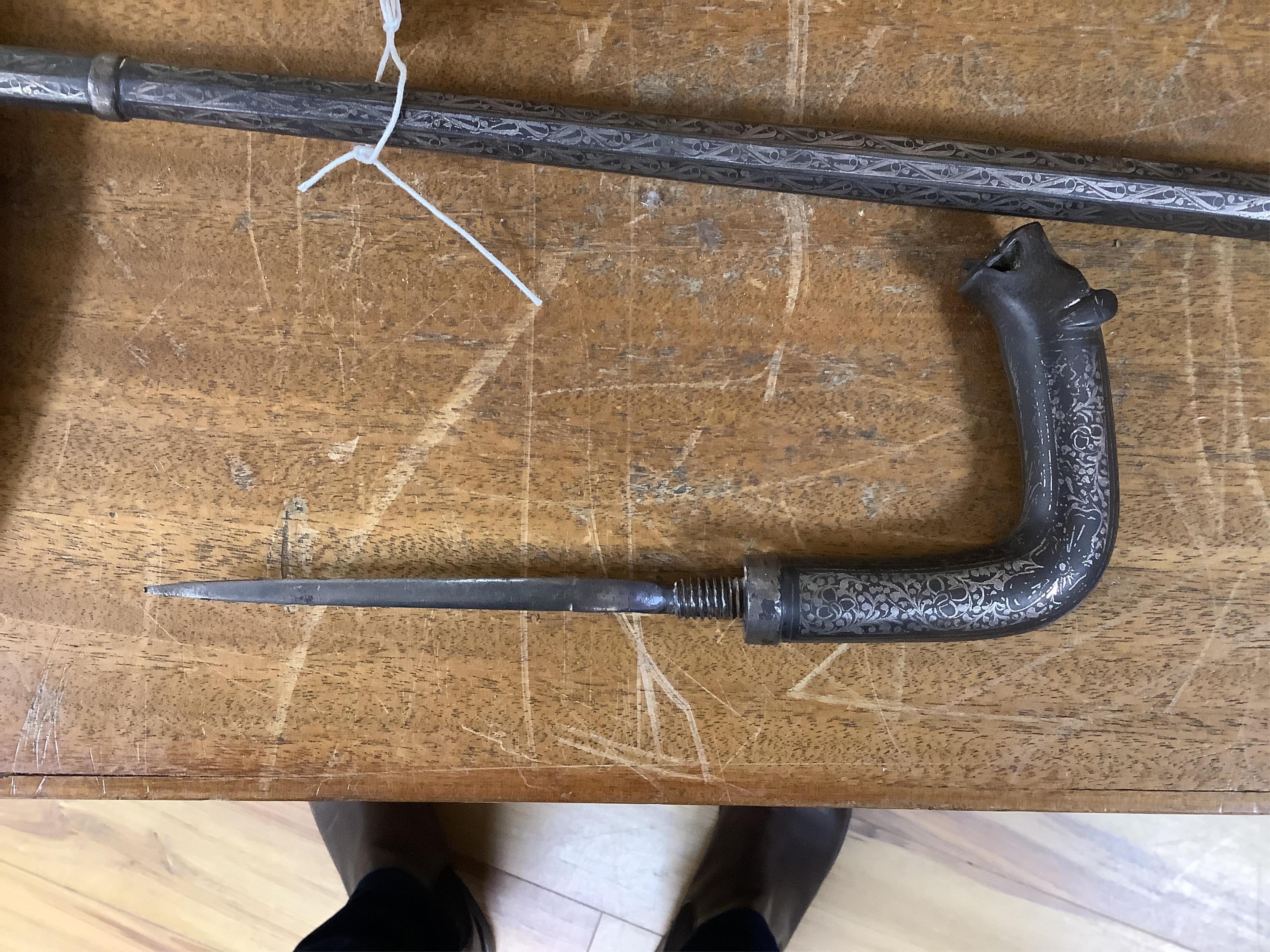 A 19th century Indian bidriware swordstick with stylised leopard handle, blade 14cm, overall length 97cm. Condition - fair to good, some surface wear.